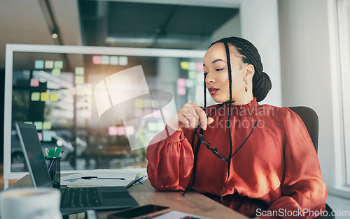 Image of Woman in office with laptop, research and reading email, ideas on website for business plan and brainstorming. Thinking, internet and businesswoman on computer for online review feedback at startup.