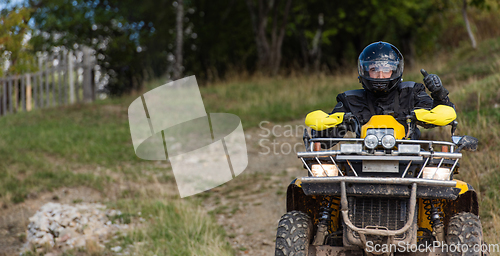 Image of Adventurous driving of ATV motorbikes. A man drives a quad bike on dangerous roads