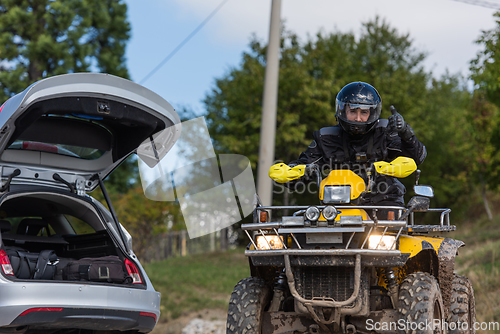 Image of Adventurous driving of ATV motorbikes. A man drives a quad bike on dangerous roads