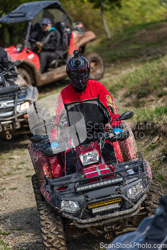 Image of Adventurous driving of ATV motorbikes. A man drives a quad bike on dangerous roads