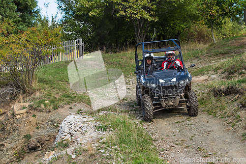 Image of Adventurous driving of ATV motorbikes. A man drives a quad bike on dangerous roads