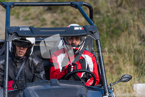 Image of A man driving a quad ATV motorcycle through beautiful meadow landscapes