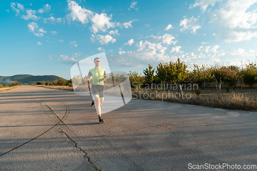 Image of Triathlete in professional gear running early in the morning, preparing for a marathon, dedication to sport and readiness to take on the challenges of a marathon.