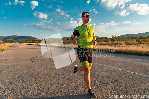 Image of Triathlete in professional gear running early in the morning, preparing for a marathon, dedication to sport and readiness to take on the challenges of a marathon.