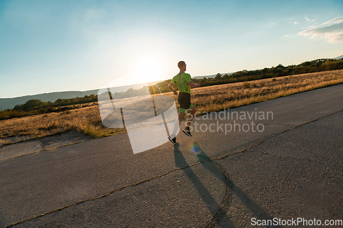 Image of Triathlete in professional gear running early in the morning, preparing for a marathon, dedication to sport and readiness to take on the challenges of a marathon.