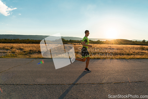 Image of Triathlete in professional gear running early in the morning, preparing for a marathon, dedication to sport and readiness to take on the challenges of a marathon.