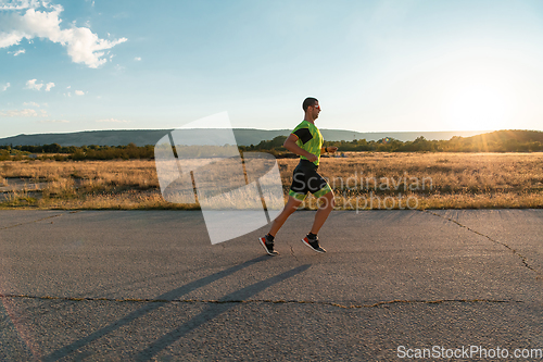 Image of Triathlete in professional gear running early in the morning, preparing for a marathon, dedication to sport and readiness to take on the challenges of a marathon.