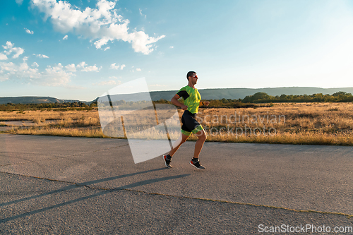 Image of Triathlete in professional gear running early in the morning, preparing for a marathon, dedication to sport and readiness to take on the challenges of a marathon.