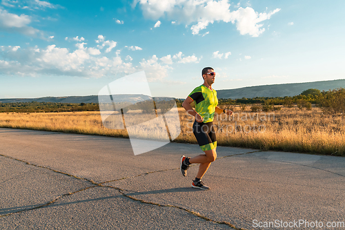 Image of Triathlete in professional gear running early in the morning, preparing for a marathon, dedication to sport and readiness to take on the challenges of a marathon.