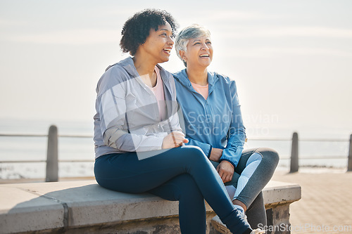 Image of Senior women, sitting and beach with friends, training and laugh in summer outdoor. Exercise, break and mature female in the morning with funny joke and workout for wellness and health by sea