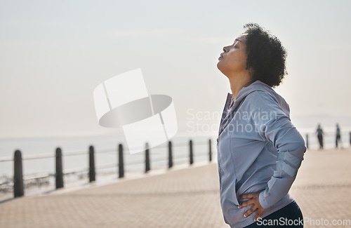 Image of Beach, tired and woman with fitness, sports and health with wellness, workout goals and running. Outdoor, female person or athlete breathing, exercise and mockup space with fatigue, ocean and profile