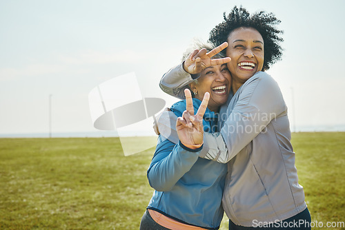 Image of Senior, women hug and fitness, peace hand sign and portrait with friends, energy and playful outdoor. Happy female people, friendship and cool with sportswear in park, exercise and fun together