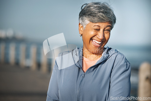 Image of Senior, fitness and woman portrait with wink at beach happy with walking, running or morning cardio in nature. Smile, face and cheerful elderly female at the sea for workout, exercise or sports walk