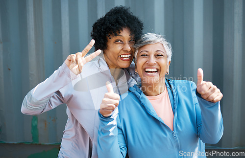 Image of Mature, women and friends, portrait and fitness, peace hand gesture with thumbs up pose and playful outdoor. Female people, friendship and cool in sportswear, exercise and fun together with wellness