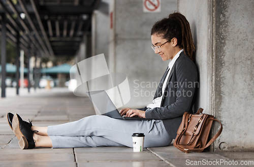 Image of Laptop, typing and woman on a coffee break in the city or employee relax on social media, internet or online connection. Remote, virtual work and digital nomad or person sitting on computer on street