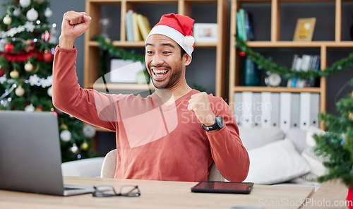 Image of Laptop, christmas and remote work with a winner man in his home office for the celebration of an achievement. Computer, success and motivation with a happy entrepreneur cheering a sale, bonus or deal