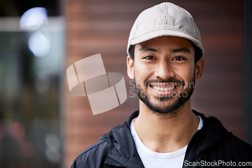 Image of Courier man, outdoor headshot and portrait for service, delivery or smile for supply chain job. Young logistics worker, face and city for customer satisfaction, mockup space or ecommerce in metro cbd