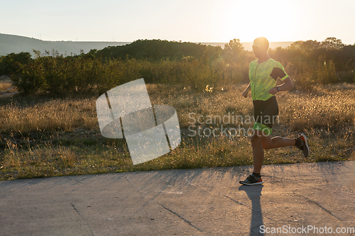 Image of Triathlete in professional gear running early in the morning, preparing for a marathon, dedication to sport and readiness to take on the challenges of a marathon.