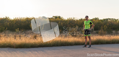 Image of A triathlete resting after a hard morning's run. Training preparation for the upcoming marathon