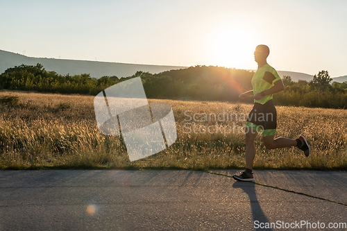 Image of Triathlete in professional gear running early in the morning, preparing for a marathon, dedication to sport and readiness to take on the challenges of a marathon.