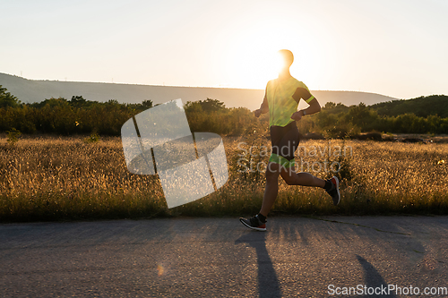 Image of Triathlete in professional gear running early in the morning, preparing for a marathon, dedication to sport and readiness to take on the challenges of a marathon.