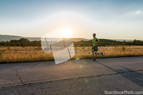 Image of Triathlete in professional gear running early in the morning, preparing for a marathon, dedication to sport and readiness to take on the challenges of a marathon.