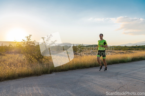 Image of Triathlete in professional gear running early in the morning, preparing for a marathon, dedication to sport and readiness to take on the challenges of a marathon.