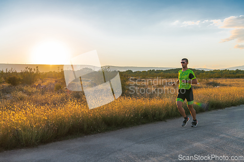 Image of Triathlete in professional gear running early in the morning, preparing for a marathon, dedication to sport and readiness to take on the challenges of a marathon.