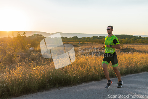 Image of Triathlete in professional gear running early in the morning, preparing for a marathon, dedication to sport and readiness to take on the challenges of a marathon.