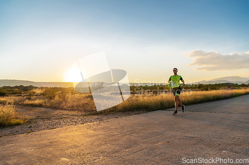 Image of Triathlete in professional gear running early in the morning, preparing for a marathon, dedication to sport and readiness to take on the challenges of a marathon.