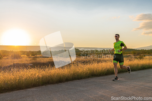 Image of Triathlete in professional gear running early in the morning, preparing for a marathon, dedication to sport and readiness to take on the challenges of a marathon.