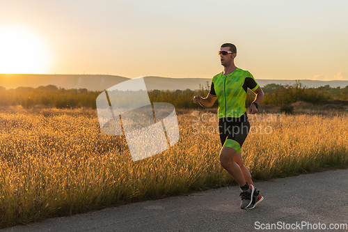 Image of Triathlete in professional gear running early in the morning, preparing for a marathon, dedication to sport and readiness to take on the challenges of a marathon.