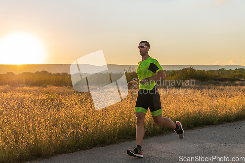 Image of Triathlete in professional gear running early in the morning, preparing for a marathon, dedication to sport and readiness to take on the challenges of a marathon.