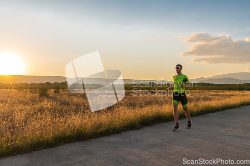 Image of Triathlete in professional gear running early in the morning, preparing for a marathon, dedication to sport and readiness to take on the challenges of a marathon.