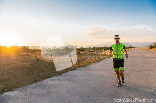 Image of Triathlete in professional gear running early in the morning, preparing for a marathon, dedication to sport and readiness to take on the challenges of a marathon.