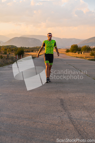 Image of Triathlete in professional gear running early in the morning, preparing for a marathon, dedication to sport and readiness to take on the challenges of a marathon.