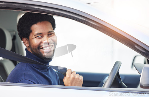 Image of African driver man, seat belt and smile in portrait for safety, warning or reminder for travel, transport or ride. Young guy, new car and happy with freedom, excited and security to stop crash injury