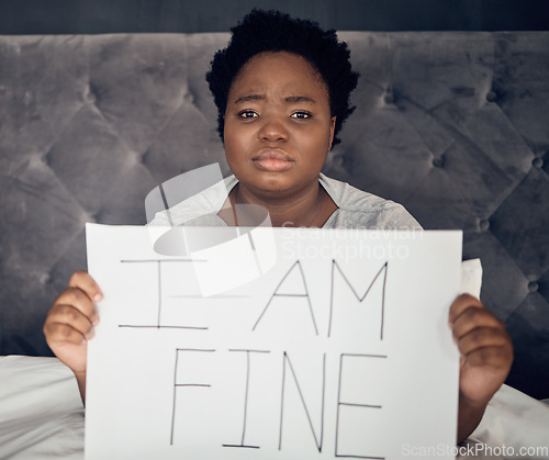 Image of Portrait, sign and black woman with depression, sad and anxiety in home bedroom. Mental health, face and African person with poster for stress, challenge and life crisis, frustrated and in denial