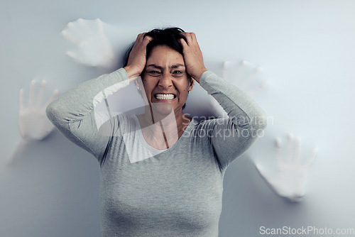 Image of Portrait, screaming and senior woman with anxiety, depression and trauma with mental health. Angry face, female person or model with stress, frustrated and psychology with fear on a studio background