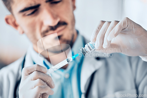 Image of Man, doctor and syringe with vial for vaccine, healthcare or medication for injection at the hospital. Male person or medical professional holding needle for covid dose, diagnosis or drugs at clinic