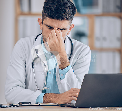 Image of Man, doctor and headache with laptop in stress, mistake or debt from burnout or deadline at hospital. Frustrated male person or medical employee in anxiety, depression or mental health at the clinic