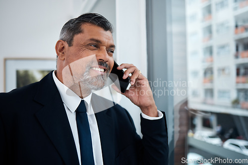 Image of Happy businessman, phone call and window in office building for communication, networking and discussion. Boss, CEO and executive manager thinking while talking on smartphone conversation in company