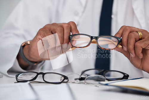 Image of Hands, man and optician with choice of glasses for vision, eyesight and prescription eye care. Closeup of doctor, optometrist and decision for frame, lens and eyewear of optical healthcare assessment