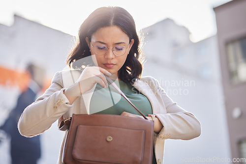 Image of Business woman, handbag searching and employee in city looking to find in purse. Urban, young and professional with missing and lost item in bag for career and commute to work with worker on street