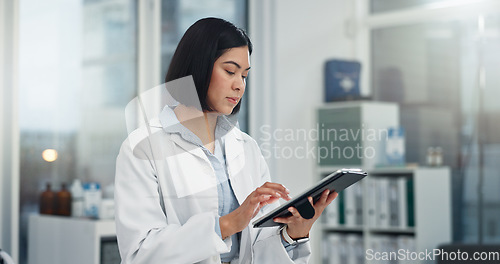 Image of Tablet, typing and woman or doctor, hospital or clinic office for healthcare software, telehealth or research. Search, online charts or report of medical professional or asian person on digital tech