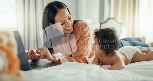 Image of Love, laptop and mother with baby in a bed for bonding, relax and playing in their home. Family, social media and female mom influencer with newborn in a bedroom and content creation for online blog