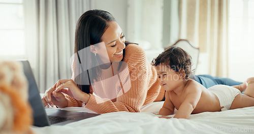 Image of Remote work, love and mother with baby in a bed for bonding, relax and playing in their home. Work from home, freelance and female relax with newborn, happy and smile while having fun in a bedroom