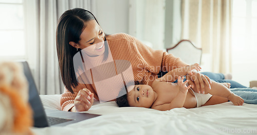 Image of Remote work, love and mother with baby in a bed for bonding, relax and playing in their home. Work from home, freelance and female relax with newborn, happy and smile while having fun in a bedroom