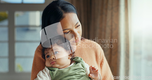 Image of Love, mom holding baby in home and bonding with care and hug, holding hands and rocking to calm child. New mother with newborn and safety and support from woman thinking of future comfort in house.