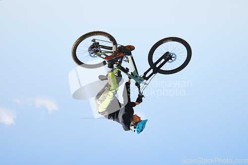 Image of Bike, man and upside down in sky for action, bicycle stunt and challenge on mockup space. Biker, sports athlete and courage for air jump, energy and freedom of risk in cycling contest, race and show